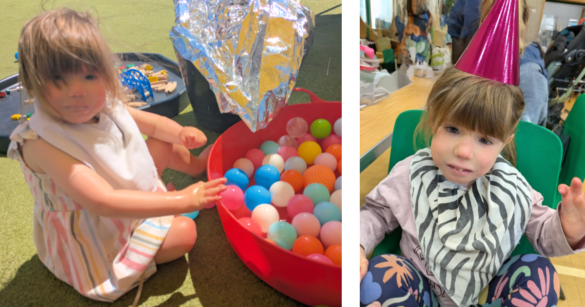 Orla with a hat and sat by a ballpit