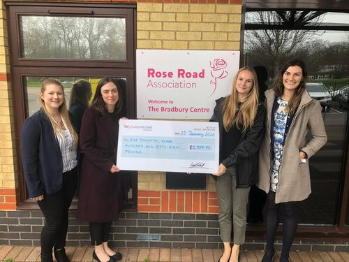 Irwin Mitchell staff hand over giant cheque