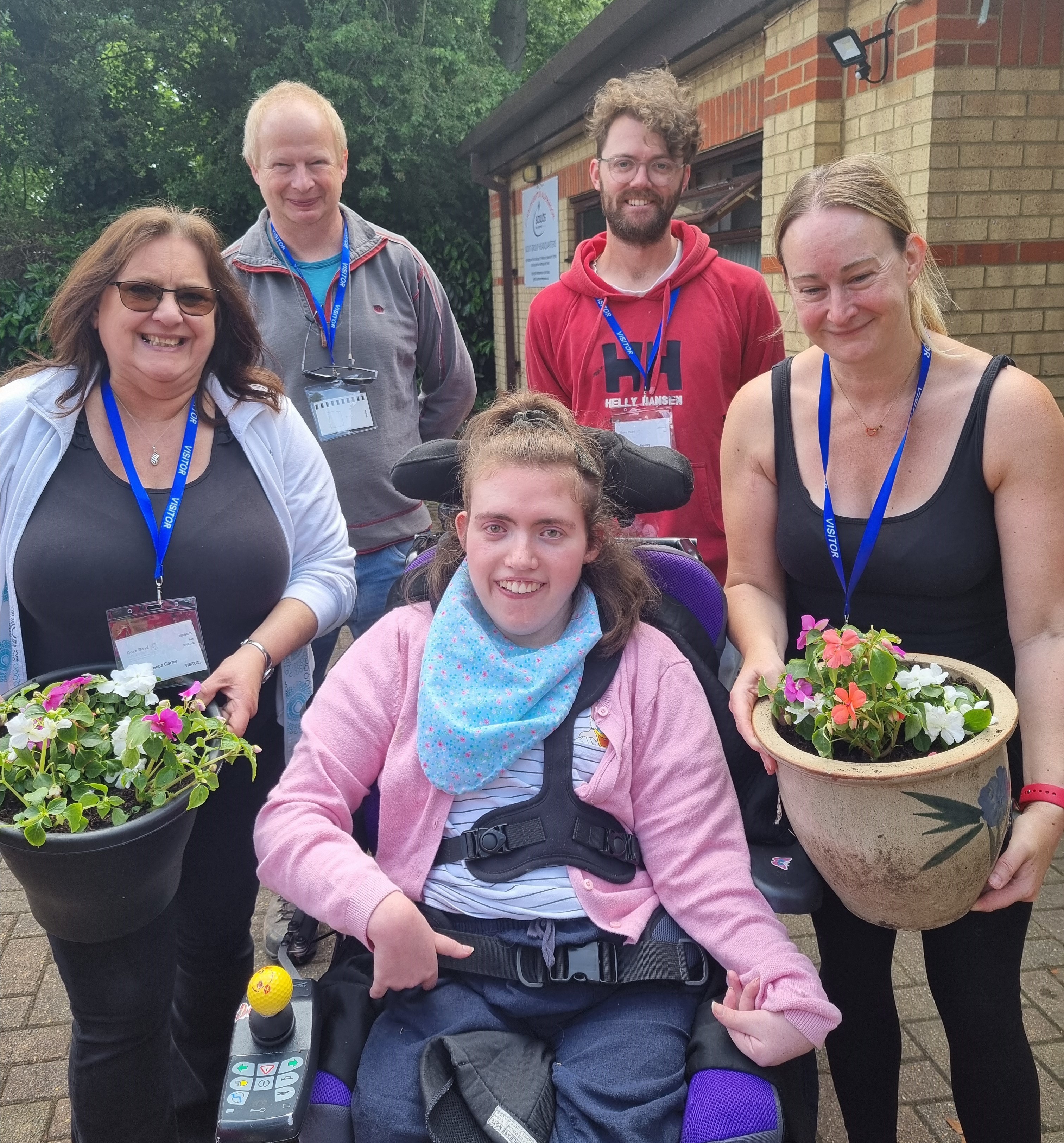NATS team in the garden with a young person